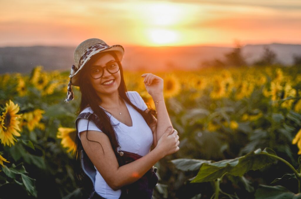 Person smiling while looking at sun rise over mountains